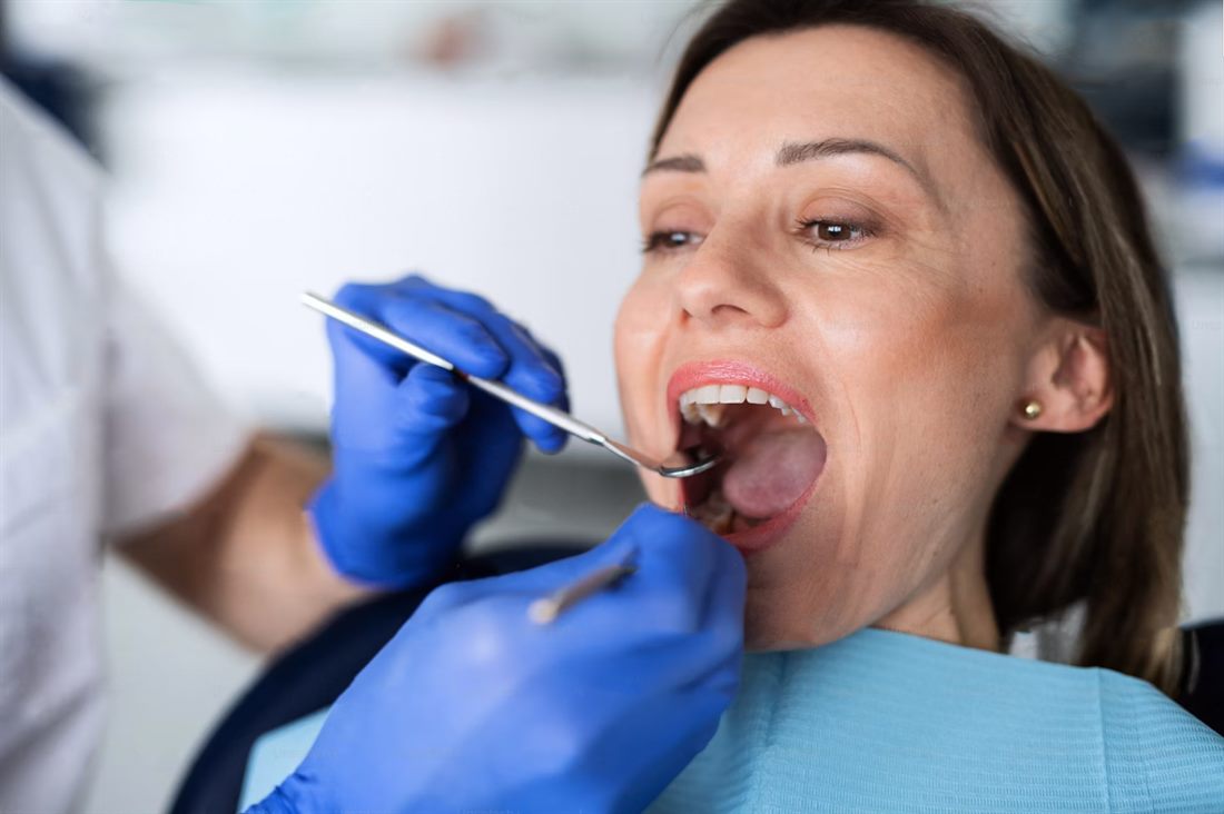 Dentist examining a patient's teeth at White Dent clinic